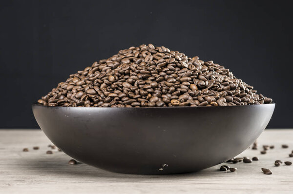 Coffee beans in wooden bowl