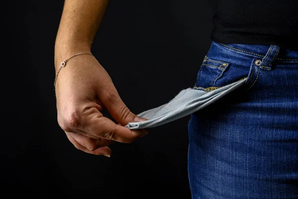 Woman turning her pockets inside out being broke