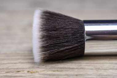 Make up powder brush on wooden table