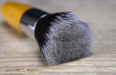 Make up powder brush on wooden table