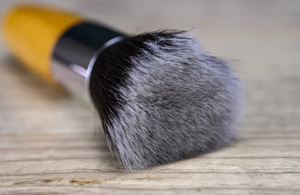 Make up powder brush on wooden table