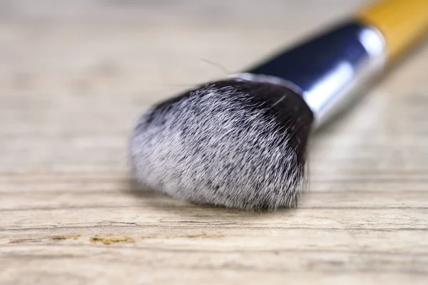 Make up powder brush on wooden table