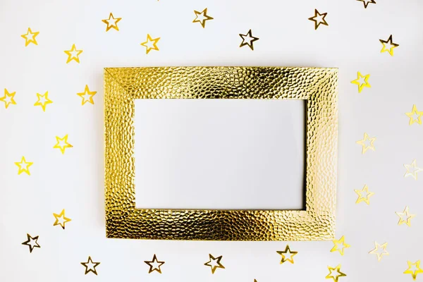 Photo frame mock up with space for text, golden confetti on white background. Lay Flat, top view. Valentine's minimal background.