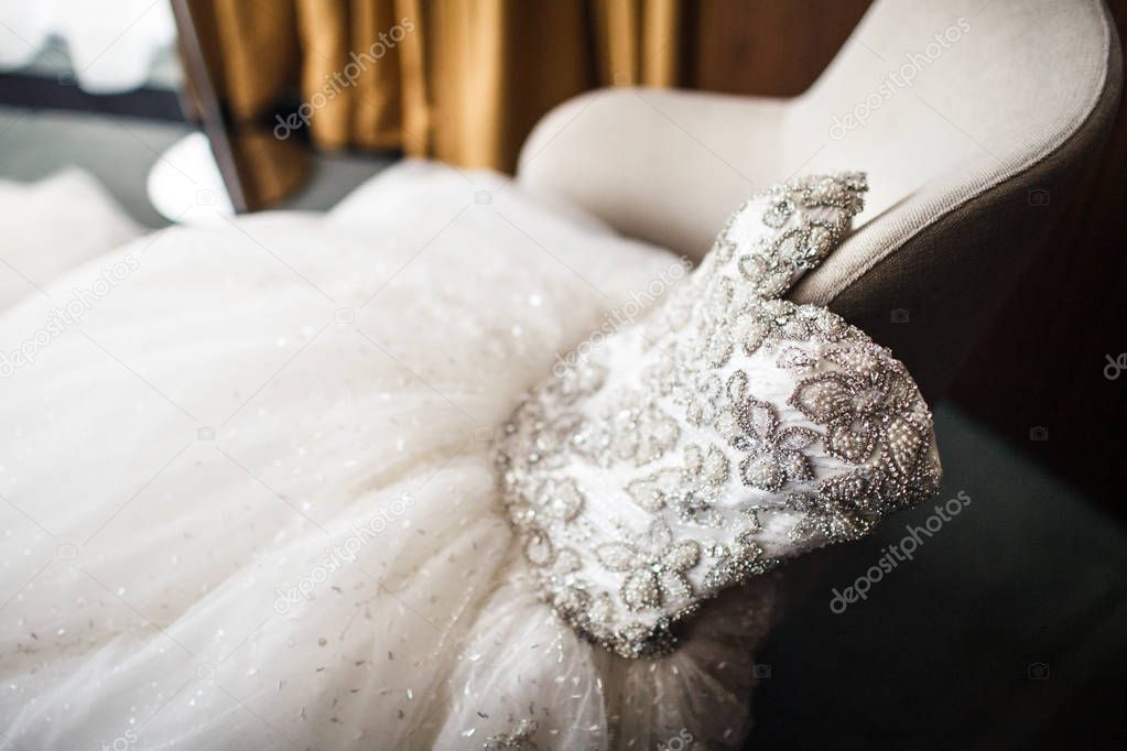 Wedding dress on the vintage chair, close-up