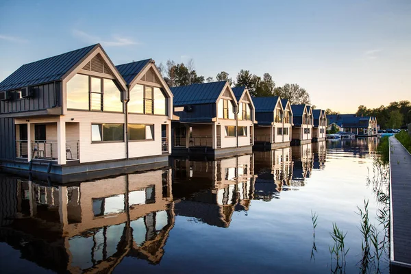 Row of houses with mirror windows on the lake