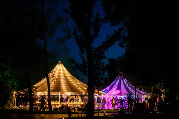 Colorful wedding tents at night. Wedding day