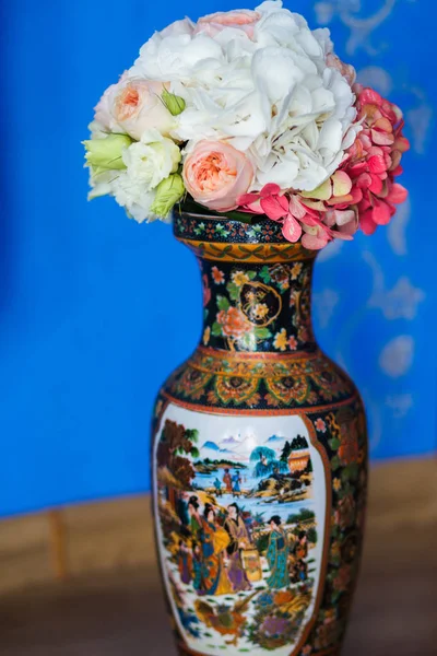 Beautiful flowers in vase with light from window. Wedding bouquet