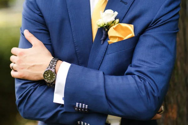 The groom in blue suit, watch and boutonniere — Stock Photo, Image