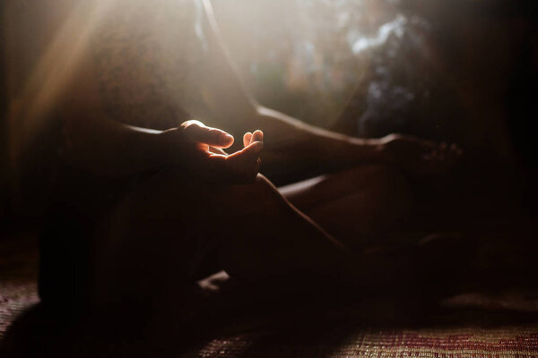girl in lotus pose in meditation with smoke