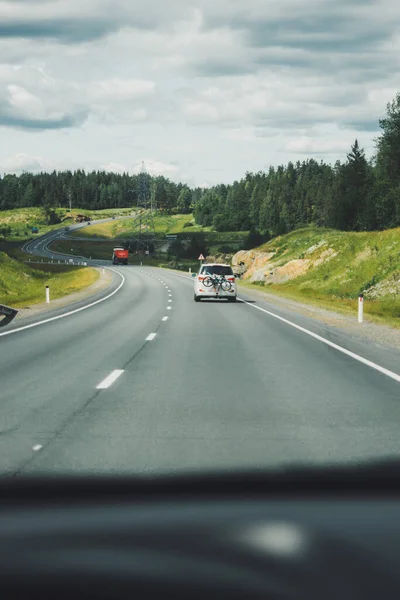 Car driving on winding road for new adventures POV