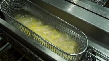 Taze dilimlenmiş saman patates patates kızartması keşfedilmeyi bekleyen kaynar yağda batırma vardır