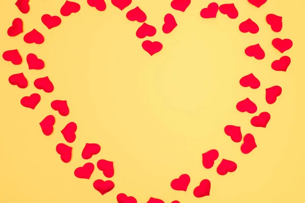 Heart shaped frame on yellow background. Copy space. Valentine\'s day concept.