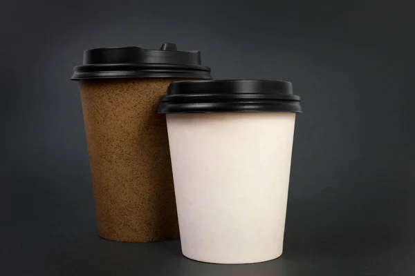 Take away coffee cups with lids on black background. Coffee to go concept.