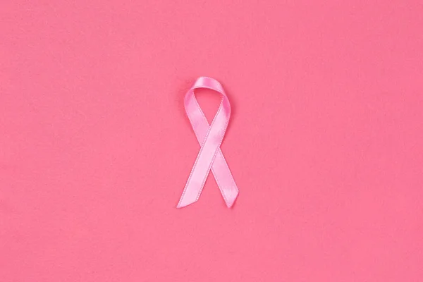 Pink ribbon on pink background. Breast cancer concept