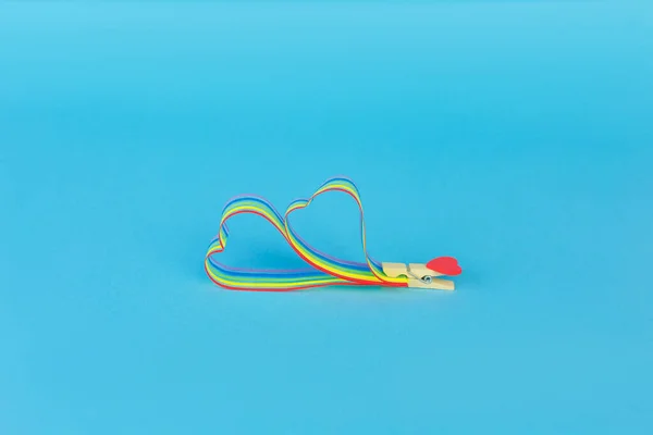 Rainbow ribbon awareness for LGBT community on blue background