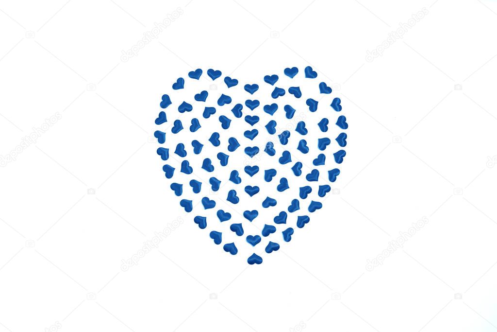 One blue big heart made up of many little hearts inside on white background