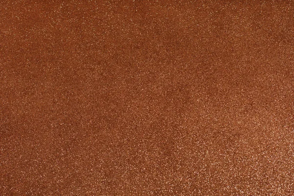 Dark gold copper glitter texture background. Brown glitter