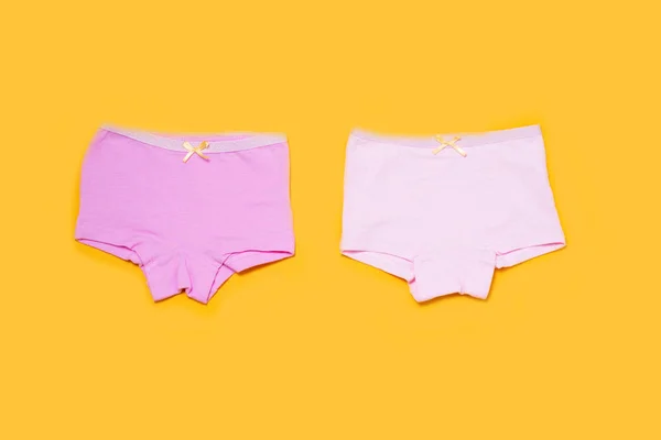 Underwear clothes for baby girl on yellow background. — 图库照片