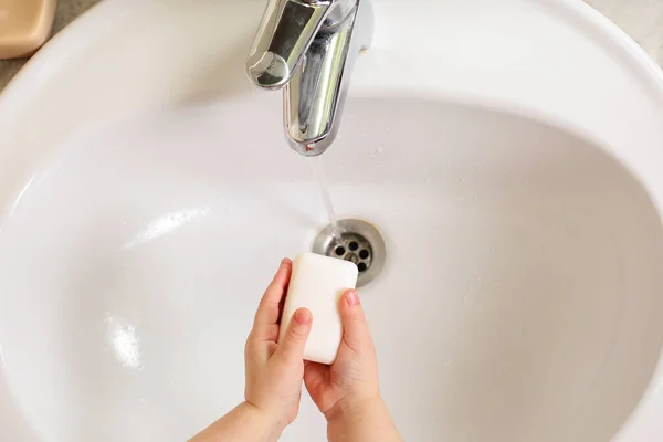 Child washing hands with soap under the tap with water — Stock Photo, Image