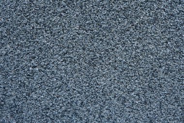 Küçük siyah ve gri taşlardan yapılmış duvar. Çimentoya çakıl. Beton karışım dokusu duvarı.
