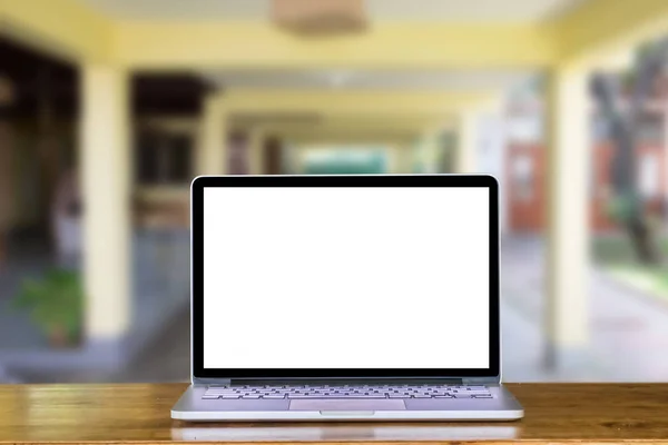 Front view of laptop on table in home blurred background. Laptop with blank screen and can be add your texts or others.