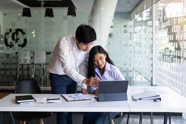 Young modern businessman and woman working together in modern co-work space.