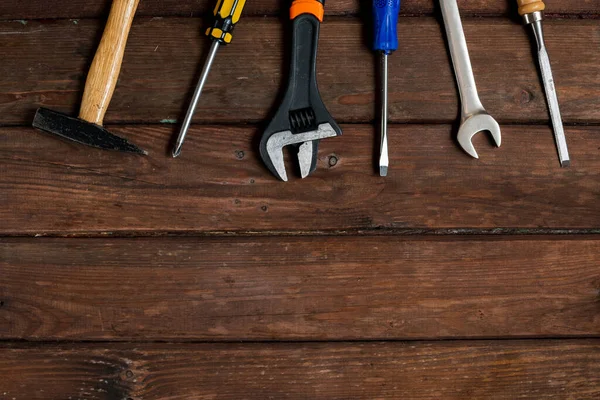 Happy Fathers Day tools, hammer on a rustic wood background. Group of repair tools on wooden background. Space for text.