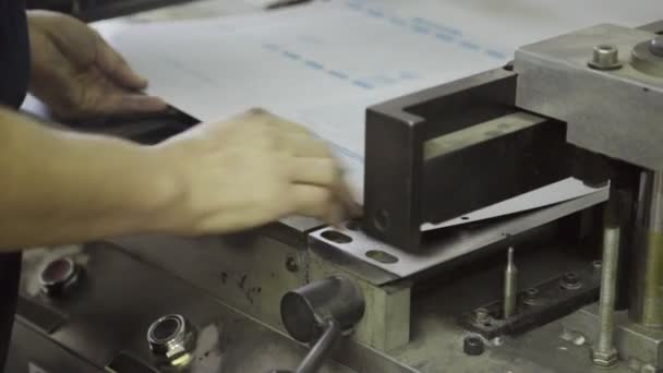 Homme dans l'impression plie coins sur feuille de papier sur la machine . — Video