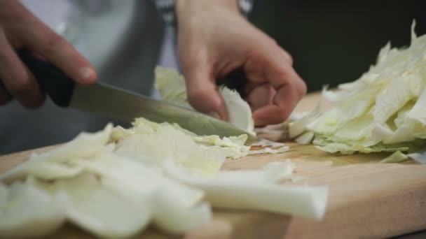 Cook separates the leaves from the stalks of Chinese cabbage. — Stock Video