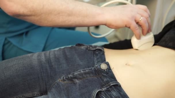 Doctor holds an abdominal ultrasound to the patient in the hospital. — Stock Footage Doctor holds an abdominal ultrasound to the patient in the hospital. Stock Footage
