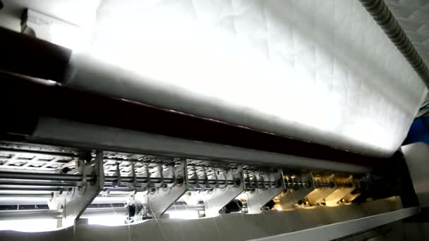 Stitching fabric for orthopedic mattress in factory indoors. — Stock Video