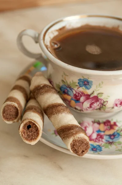 Cup of coffee and wafer biscuit rolls