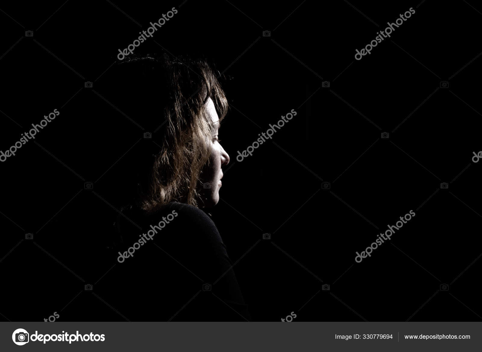 Sad Girl Profile In Dark Looking Up Stock Photo, Picture and