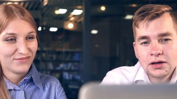 Team Members Woman and Man Look At A Laptop Together — Stock Video