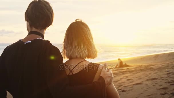 Casal na margem do mar, Casal romântico ao pôr-do-sol. Duas pessoas apaixonadas ao pôr-do-sol. Homem e mulher na praia — Vídeo de Stock