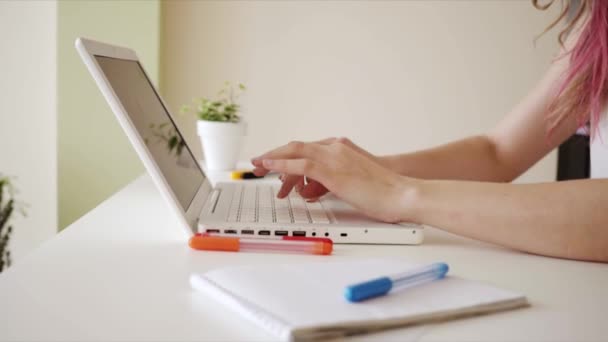 Female small business owner working from home on a laptop computer. Close-up of a young woman working on a laptop. — Stock Video