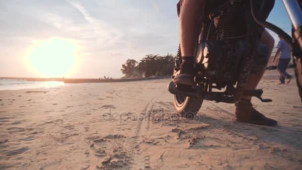 Доллі постріл екіпірування та його мотоцикл на дорозі під час заходу сонця — стокове відео