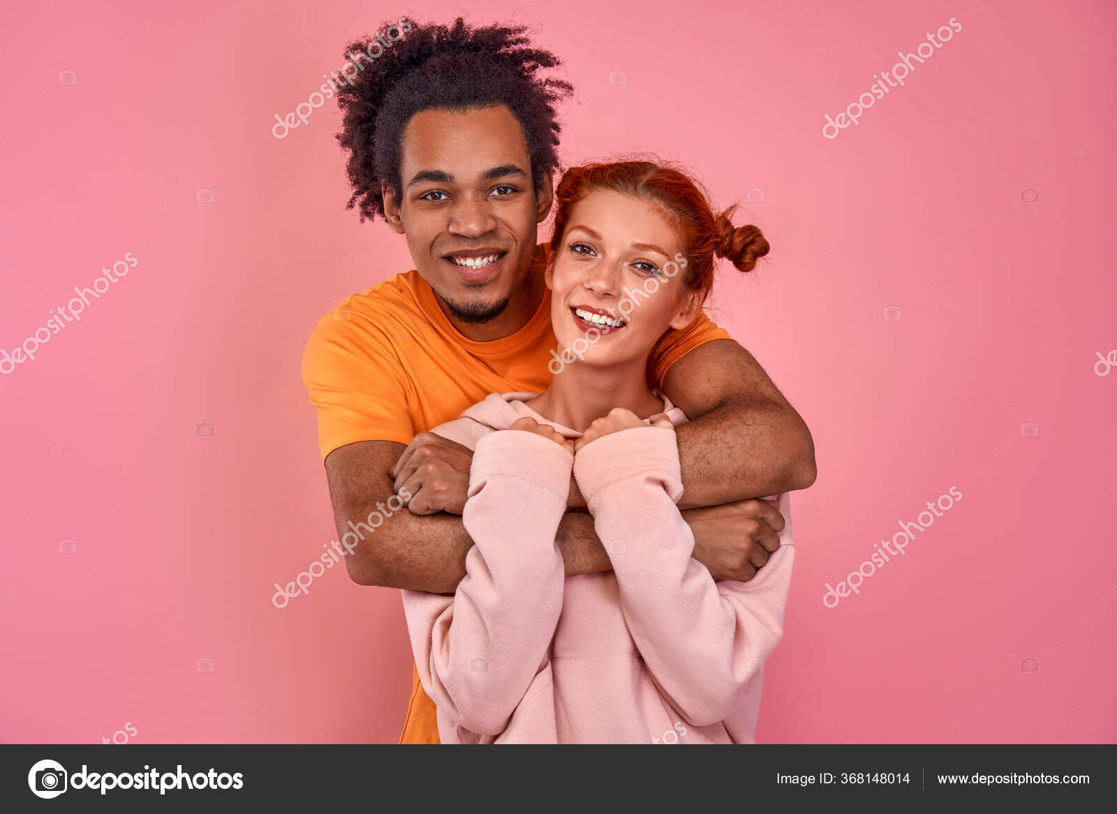 Smiling boyfriend giving piggyback ride to girlfriend against sea and sky  stock photo