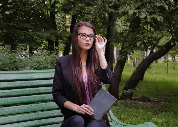 Girl with a book in the park — Stock Photo, Image