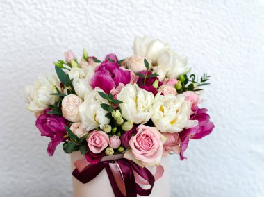 beautiful bright bouquet with roses, tulips and eustoma, on a white backgroun