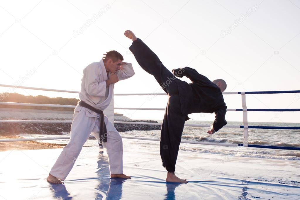 Karate fighters outdoor om the beach