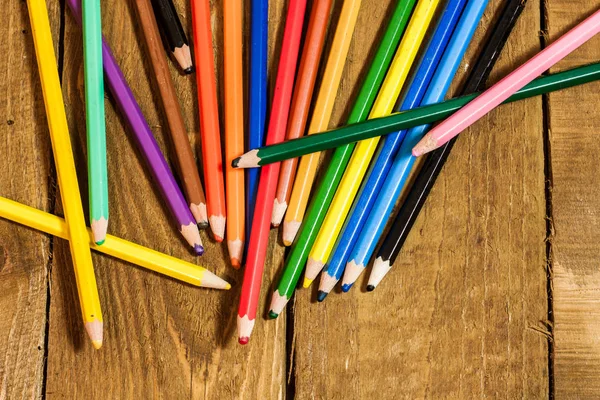 Composition with colorful pencils on old wooden table — Stock Photo, Image