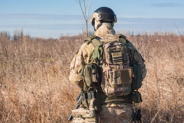 Airsoft Soldiers in posing with rifle back picture — Stock Photo, Image