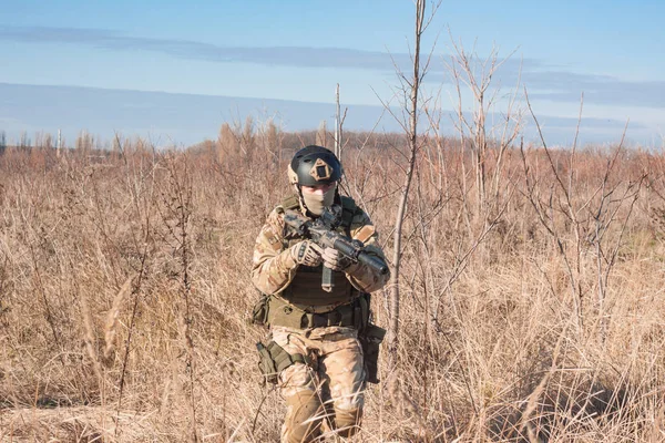 Airsoft Soldiers in posing with rifle in fields — Stock Photo, Image