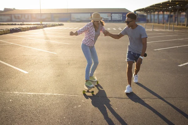 Happy young couple with skateboard, concept of happiness, love and youth.