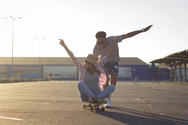 Happy young couple with skateboard, concept of happiness, love and youth.