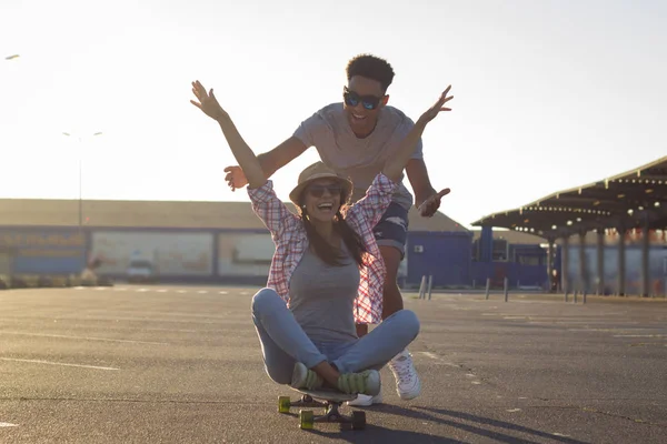 Happy young couple with skateboard, concept of happiness, love and youth.