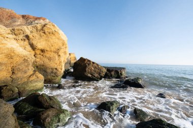 Lanscape of sea cost in sunny day and big rocks 