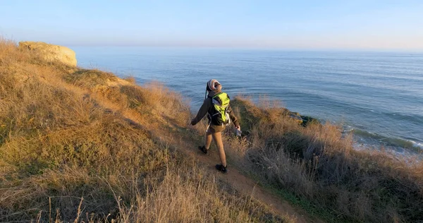 年轻的女囚犯带着背包和复古胶卷在靠近大海的秋山中旅行 — 图库照片