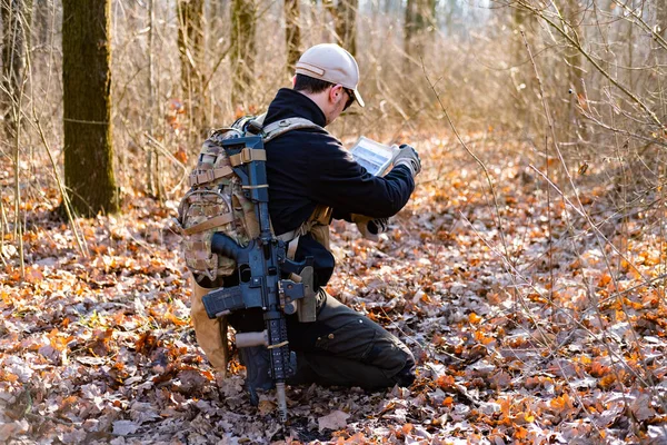 Male from private military company with rifle in the forest